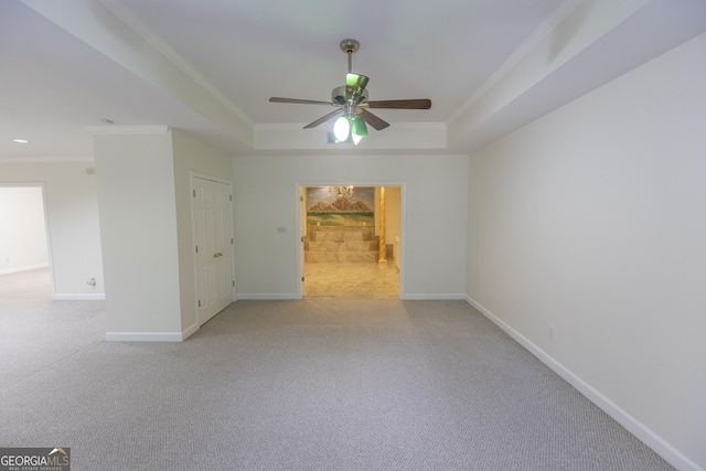 5685 Commons Ln, Alpharetta, GA 30005 - empty room featuring ornamental molding, a tray ceiling, ceiling fan, and light colored carpet