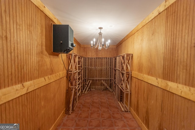 5685 Commons Ln, Alpharetta, GA 30005 - wine cellar with wooden walls and an inviting chandelier
