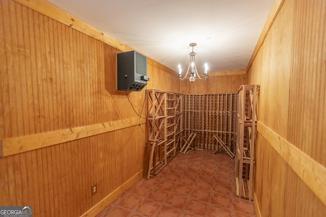 5685 Commons Ln, Alpharetta, GA 30005 - wine area with wood walls and an inviting chandelier