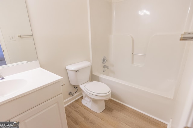 5685 Commons Ln, Alpharetta, GA 30005 - bathroom with wood finished floors, vanity, baseboards, toilet, and washtub / shower combination