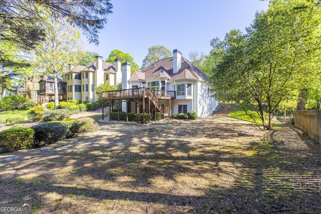 5685 Commons Ln, Alpharetta, GA 30005 - rear view of house featuring fence, a wooden deck, stairs, and a chimney
