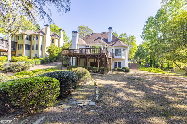 5685 Commons Ln, Alpharetta, GA 30005 - back of property featuring stairway, stucco siding, and a deck