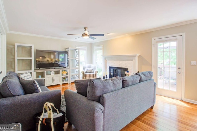 1812 Riverton Dr, Suwanee, GA 30024 - living area with crown molding, a ceiling fan, light wood-type flooring, and a brick fireplace