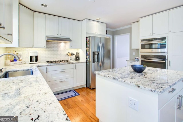 1812 Riverton Dr, Suwanee, GA 30024 - kitchen with white cabinets, stainless steel appliances, ornamental molding, and a sink