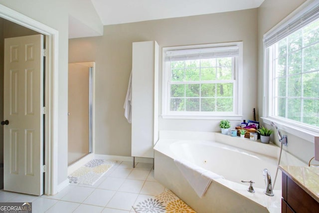 1812 Riverton Dr, Suwanee, GA 30024 - bathroom featuring a garden tub, vanity, tile patterned flooring, baseboards, and a shower stall