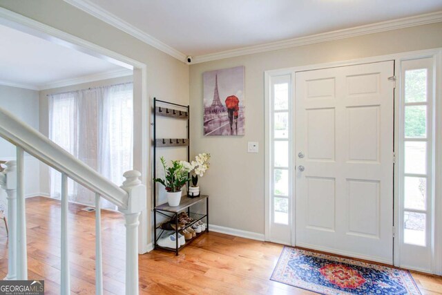 1812 Riverton Dr, Suwanee, GA 30024 - foyer featuring crown molding, baseboards, stairs, and light wood finished floors