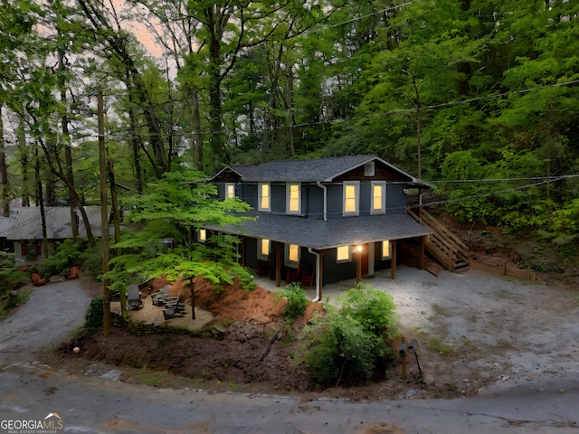 49 Toole St, Clayton, GA 30525 - view of front of home featuring a porch, roof with shingles, stairs, and a wooded view