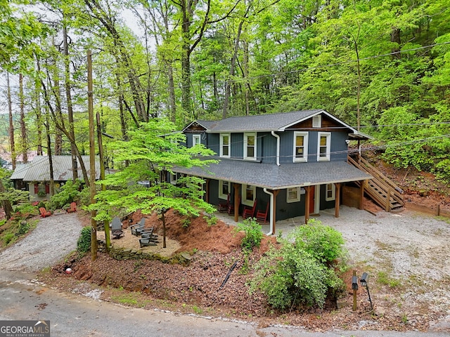 49 Toole St, Clayton, GA 30525 - view of front of home featuring covered porch, a shingled roof, stairway, and a forest view