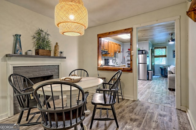 49 Toole St, Clayton, GA 30525 - dining area featuring wood finished floors, a fireplace, baseboards, and ceiling fan