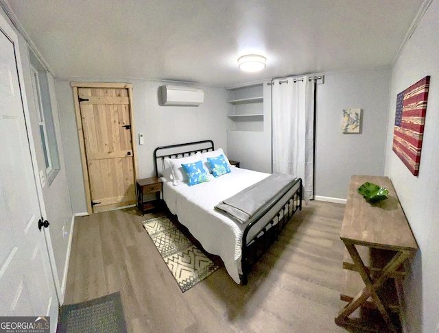 49 Toole St, Clayton, GA 30525 - bedroom featuring a wall mounted air conditioner, wood finished floors, and baseboards