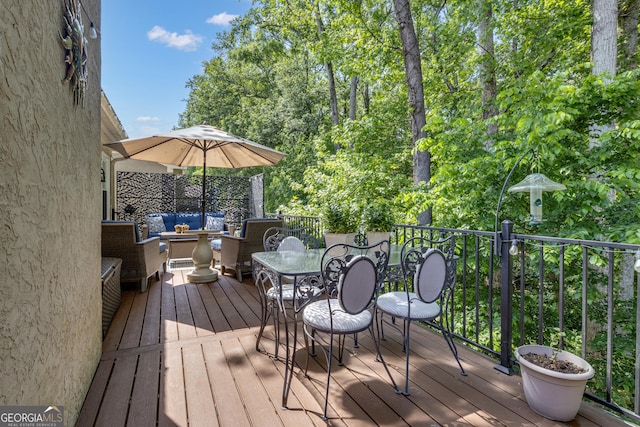 wooden terrace with outdoor lounge area and outdoor dining area