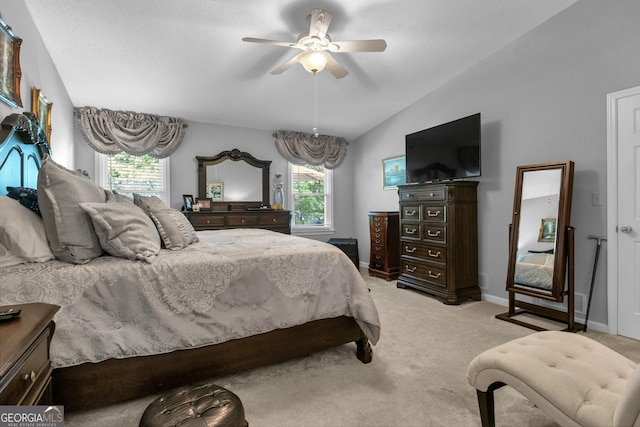 bedroom featuring light colored carpet, ceiling fan, lofted ceiling, and multiple windows