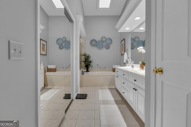 full bathroom with double vanity, a garden tub, a sink, tile patterned floors, and recessed lighting