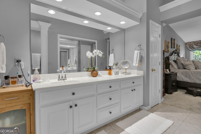 ensuite bathroom featuring tile patterned flooring, a sink, ensuite bathroom, and recessed lighting