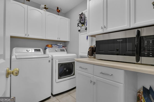 laundry room with separate washer and dryer, cabinet space, and light tile patterned flooring