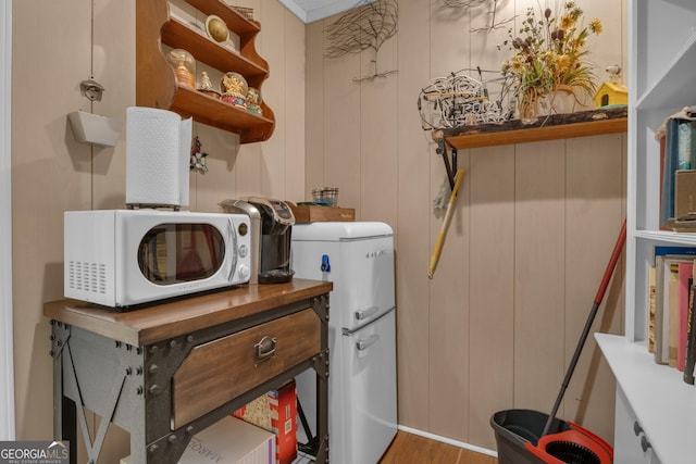 interior space with laundry area and wood finished floors