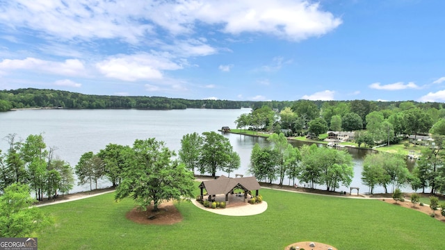 surrounding community with a gazebo, a water view, a view of trees, and a yard