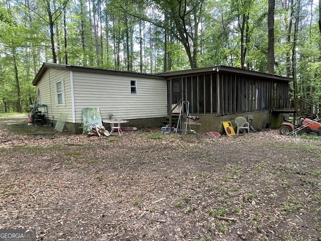 back of house with entry steps and a sunroom