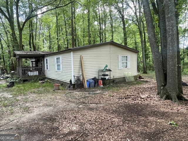 view of side of home featuring a porch and crawl space