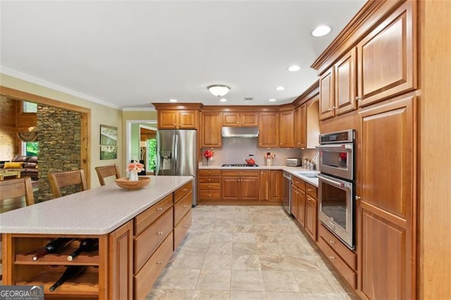 122 Gold View Dr, Dahlonega, GA 30533 - kitchen with under cabinet range hood, appliances with stainless steel finishes, open shelves, light countertops, and brown cabinetry