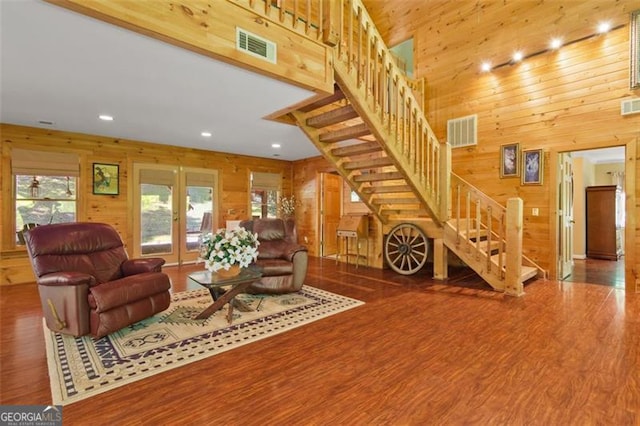 122 Gold View Dr, Dahlonega, GA 30533 - living room with wooden walls, stairs, wood finished floors, recessed lighting, and a towering ceiling