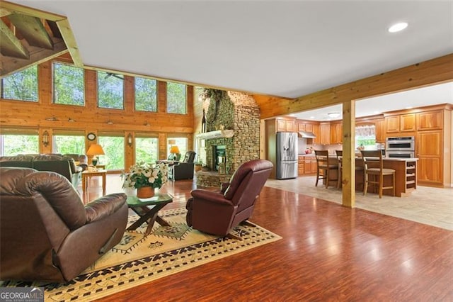 122 Gold View Dr, Dahlonega, GA 30533 - living area featuring a fireplace, recessed lighting, light wood-style flooring, and high vaulted ceiling