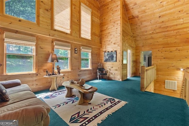 122 Gold View Dr, Dahlonega, GA 30533 - living room featuring a high ceiling, wood walls, and carpet floors