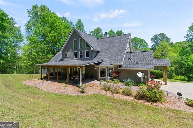 122 Gold View Dr, Dahlonega, GA 30533 - rear view of house featuring a yard, roof with shingles, a chimney, and concrete driveway