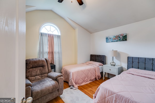 bedroom featuring ceiling fan, wood finished floors, and lofted ceiling