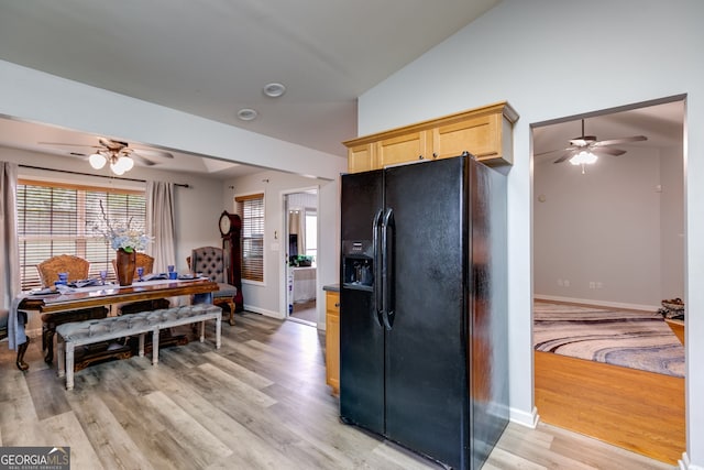 kitchen featuring baseboards, black fridge, a ceiling fan, and light wood-type flooring