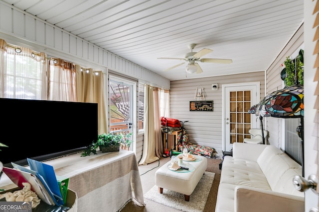 sunroom / solarium featuring a ceiling fan and an outdoor hangout area