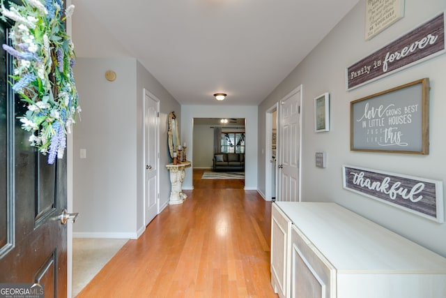 entryway with light wood-style floors and baseboards