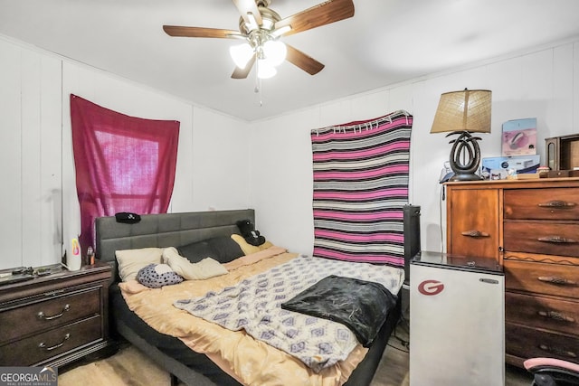 bedroom with a ceiling fan and refrigerator