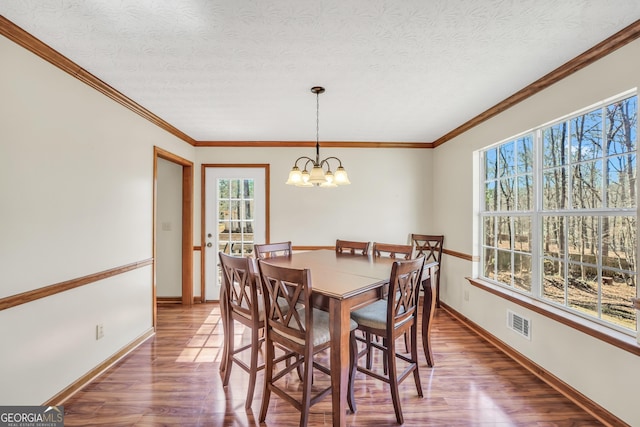 175 Laney Ct, Mcdonough, GA 30252 - dining area with an inviting chandelier, baseboards, wood finished floors, and visible vents