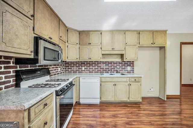 175 Laney Ct, Mcdonough, GA 30252 - kitchen featuring range with gas stovetop, dark wood-style flooring, white dishwasher, stainless steel microwave, and a sink