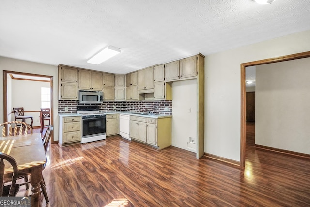 175 Laney Ct, Mcdonough, GA 30252 - kitchen featuring backsplash, white dishwasher, gas stove, a sink, and stainless steel microwave
