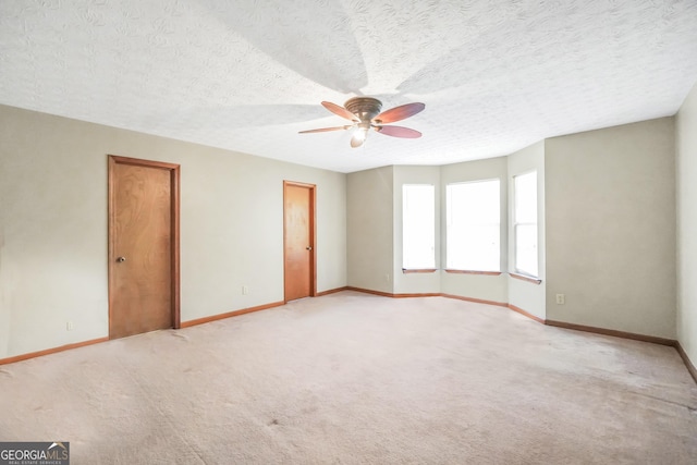 175 Laney Ct, Mcdonough, GA 30252 - unfurnished room with baseboards, ceiling fan, a textured ceiling, and light colored carpet