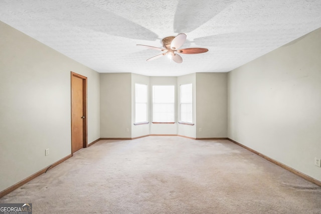 175 Laney Ct, Mcdonough, GA 30252 - spare room featuring baseboards, ceiling fan, and light carpet