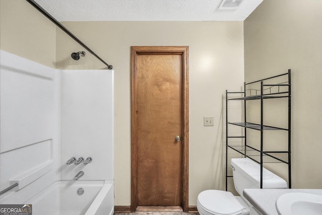 175 Laney Ct, Mcdonough, GA 30252 - bathroom featuring visible vents, vanity, toilet, washtub / shower combination, and a textured ceiling
