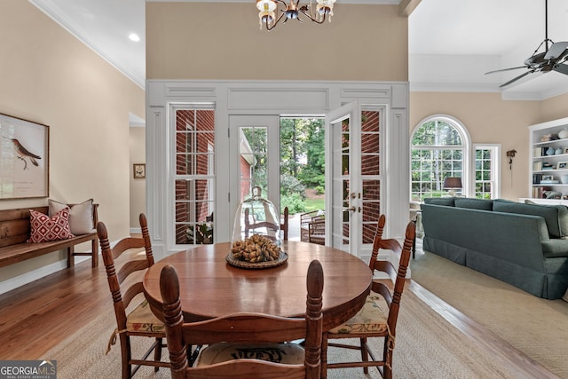 dining room featuring french doors, ornamental molding, ceiling fan with notable chandelier, and recessed lighting