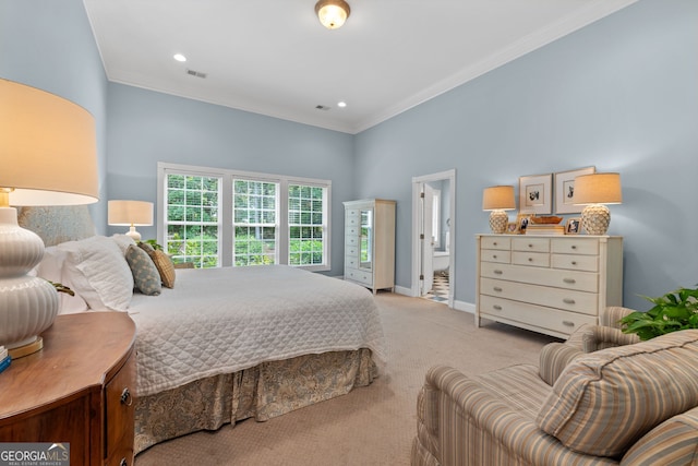 bedroom with visible vents, ornamental molding, baseboards, ensuite bathroom, and carpet