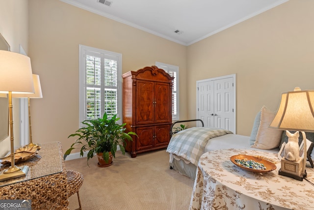 bedroom with crown molding, a closet, visible vents, and light carpet