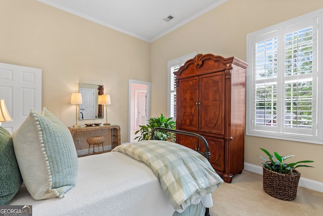 bedroom featuring visible vents, crown molding, baseboards, and carpet floors