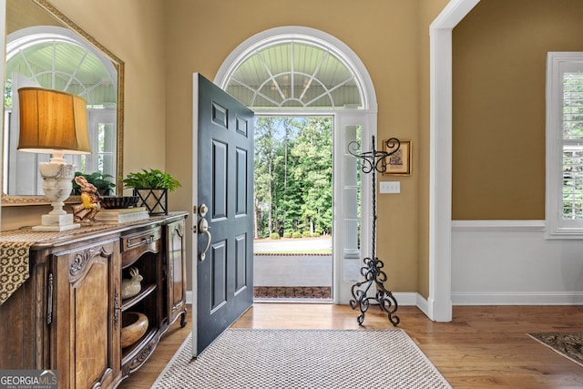 foyer featuring baseboards and wood finished floors