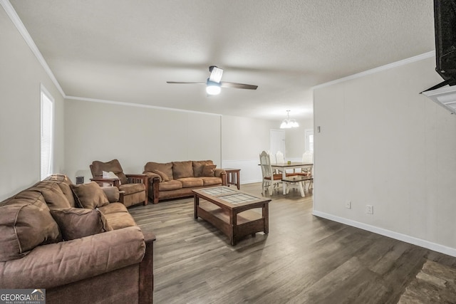 living area with crown molding, dark wood finished floors, plenty of natural light, and ceiling fan with notable chandelier