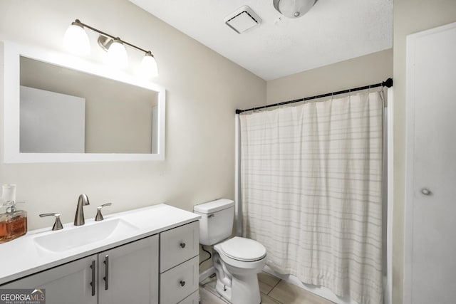 bathroom with toilet, tile patterned floors, visible vents, and vanity