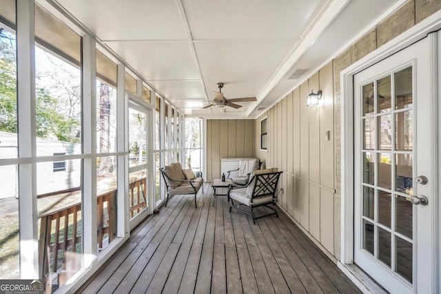 sunroom with outdoor lounge area, a ceiling fan, and visible vents