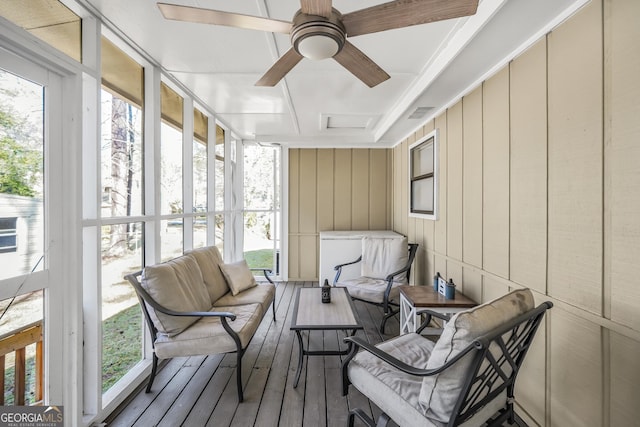 sunroom / solarium with a ceiling fan