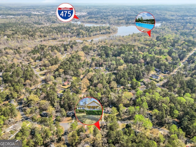 aerial view with a water view and a forest view