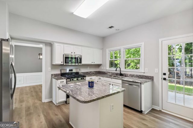 1931 Abinger Way, Lawrenceville, GA 30043 - kitchen with appliances with stainless steel finishes, light wood-style flooring, and white cabinets